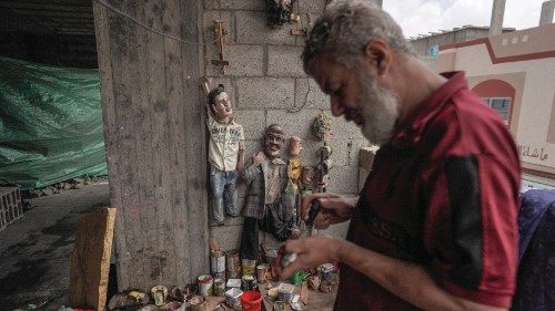 Palestinian Mahdi Karira works on a puppet at his workshop in Deir el-Balah, in the central Gaza ...