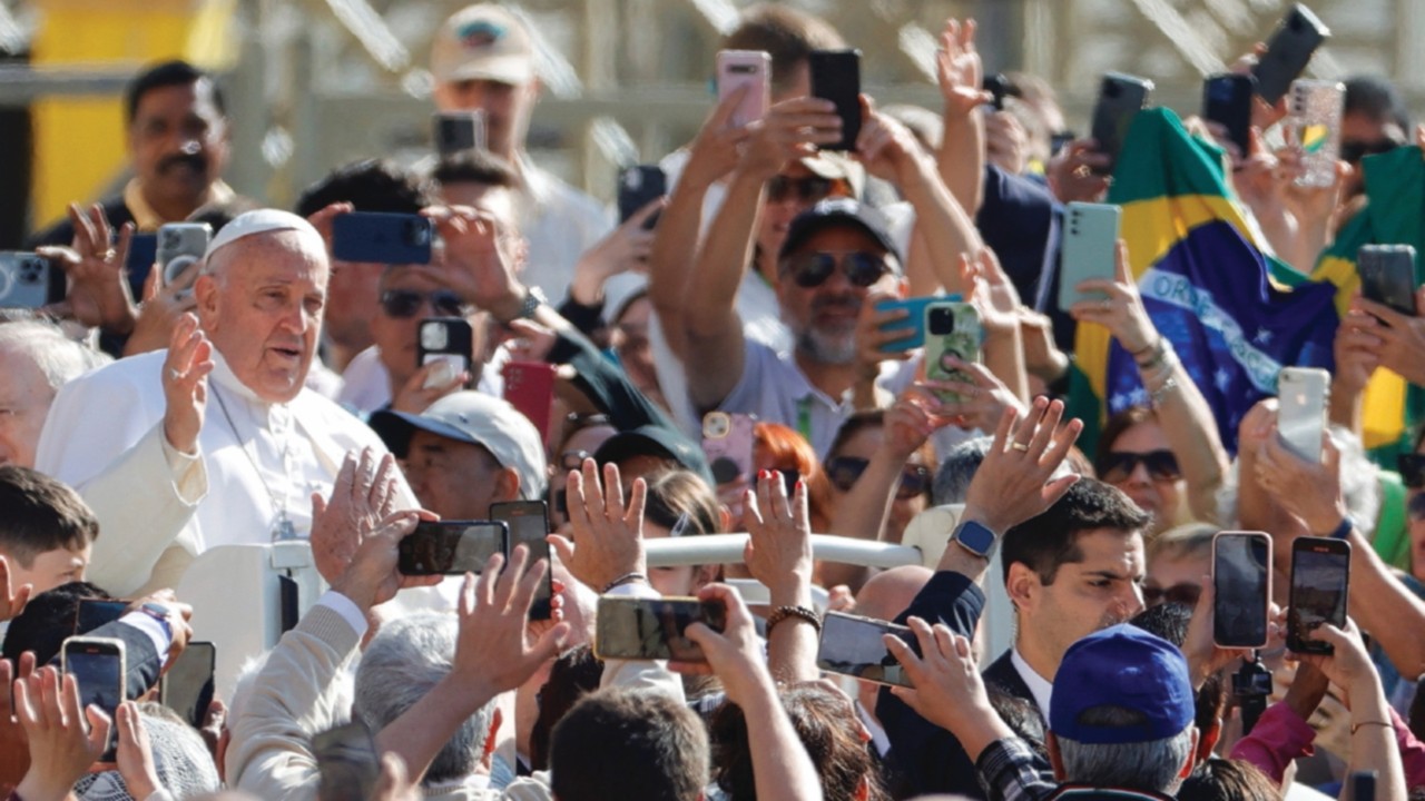 Pope Francis greets people as he arrives for the weekly general audience in Saint Peter Square at ...