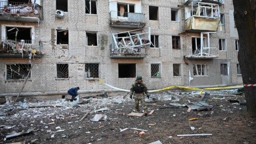 TOPSHOT - A rescuer works outside a residential building damaged as a result of Russian strikes in ...
