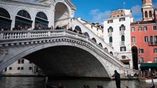 A gondola sails under the Rialto Bridge on April 24, 2024 in Venice, on the eve of the start of the ...