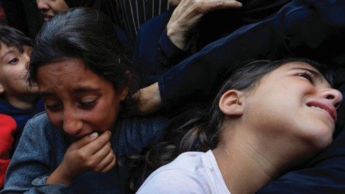 Children react during the funeral of Palestinians killed in Israeli strikes, at Nasser hospital, in ... Children react during the funeral of Palestinians killed in Israeli strikes, at Nasser hospital, in ...