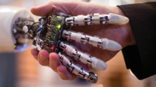 A visitor holds a hand of AILA, or Artificial Intelligence Lightweight Android, during a ... A visitor holds a hand of AILA, or Artificial Intelligence Lightweight Android, during a ...