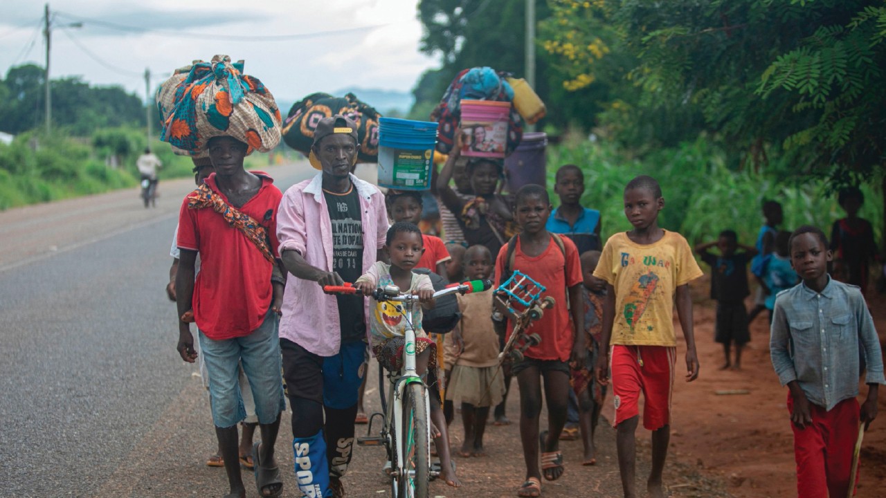 Displaced people from the province of Cabo Delgado walk through the streets of Namapa, Erati ...