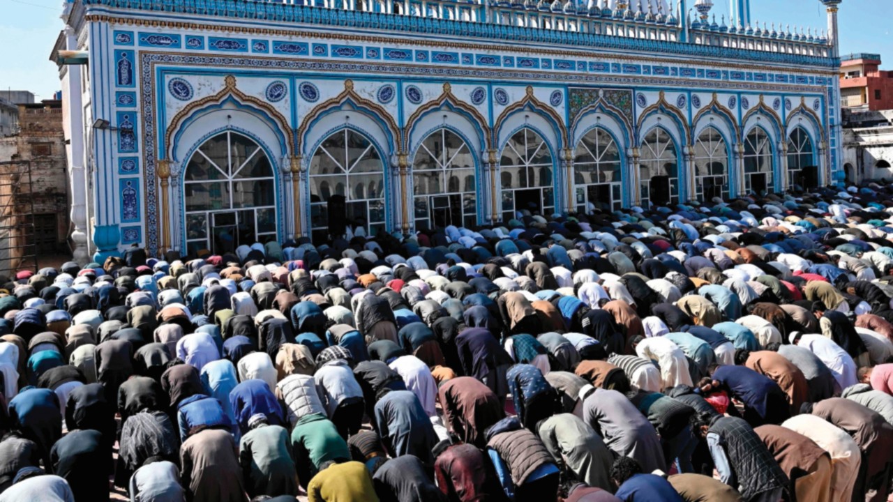 Muslim devotees offer first Friday prayers during the Islamic holy fasting month of Ramadan at a ...