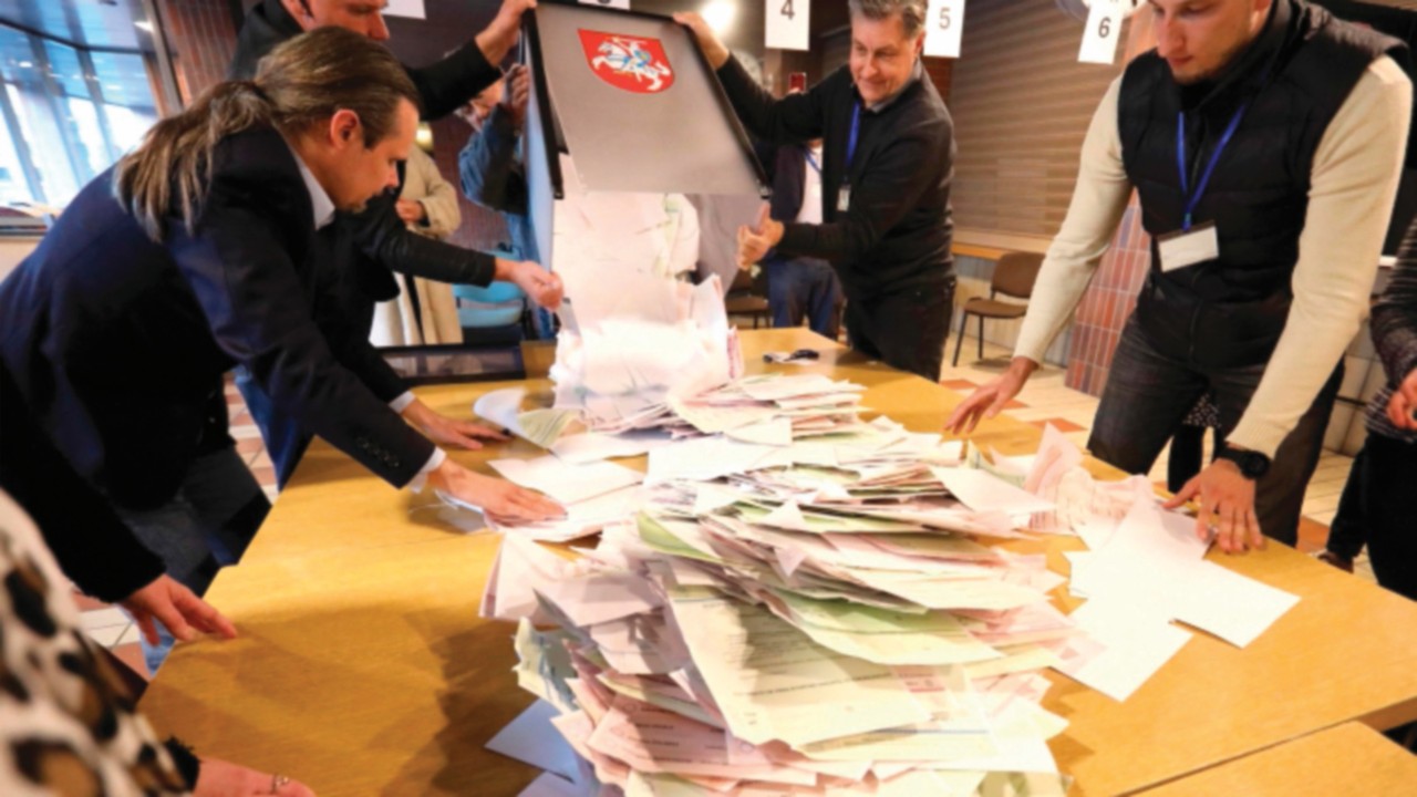 Members of a local electoral commission count ballots at a polling station during the first round of ...