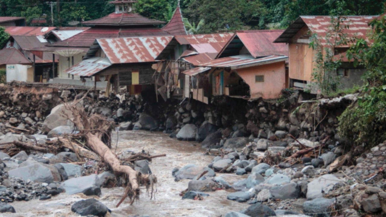 TOPSHOT - Damaged houses are seen after flash floods and cold lava flow from a volcano in Tanah ...