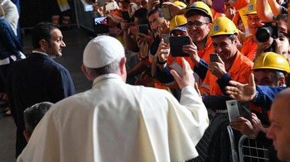 Pope Francis waves from his vehicle during his encounter with the workers of Ilva's establishment, ...
