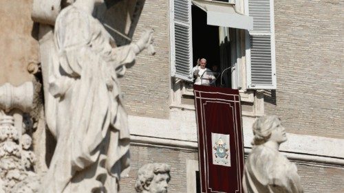 Pope Francis appears in his window during the Angelus at the Vatican, November 21, 2021. ...