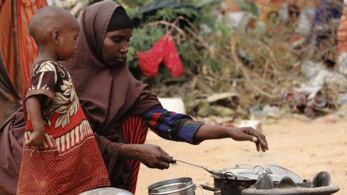 FILE PHOTO: Kadija Mohamed cooks food for her children in a camp set up for internally displaced ...