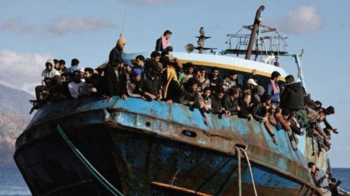 Migrants sit onboard a fishing boat at the port of Paleochora, following a rescue operation off the ...