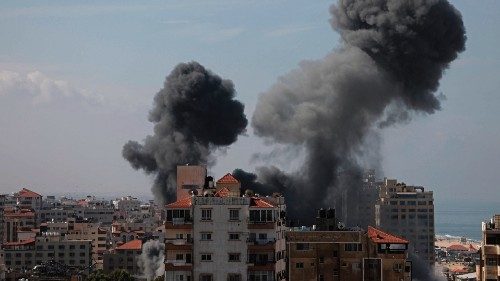 Smoke billows from a residential building following an Israeli airstrike in Gaza City on October 7, ...