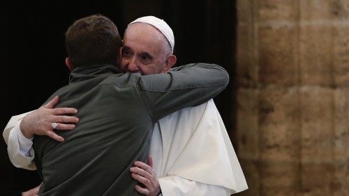 Pope Francis embraces a person as he meets with people who have made a pilgrimage to the Assisi, ...