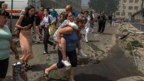 TOPSHOT - A woman carries a girl next to a heavily damaged building of the Ohmatdyt Children's ... TOPSHOT - A woman carries a girl next to a heavily damaged building of the Ohmatdyt Children's ...
