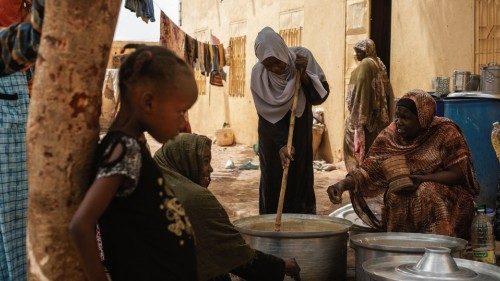 Sudanese women from community kitchens, run by local volunteers, prepare meals for people who are ... Sudanese women from community kitchens, run by local volunteers, prepare meals for people who are ...