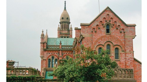 The sanctuary of Sheshan in Shanghai. On the bell tower is a bronze statue of Our Lady raising the Child