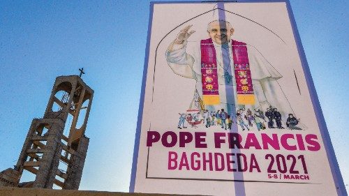 A sign welcoming Pope Francis hangs outside the Syriac Catholic Church of Mar Thoma (St Thomas), in ...
