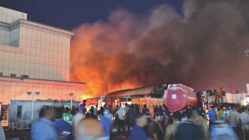 People gather as a massive fire engulfs the coronavirus isolation ward of Al-Hussein hospital in the ... People gather as a massive fire engulfs the coronavirus isolation ward of Al-Hussein hospital in the ...