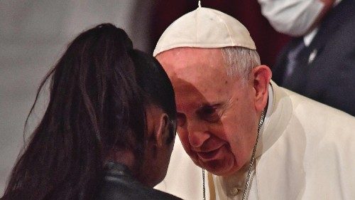 Pope Francis (R) greets a woman during an ecumenical prayer with migrants at the Roman Catholic ...
