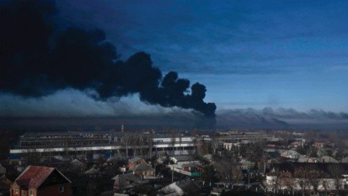 TOPSHOT - Black smoke rises from a military airport in Chuguyev near Kharkiv  on February 24, 2022. ...