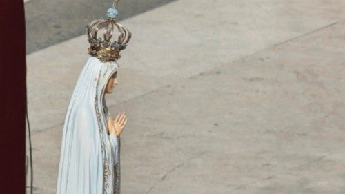 Pope Francis touches the original statue of Our Lady of Fatima after entrusting the world to Mary at ...