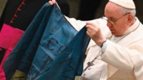 Pope Francis holds a flag of Ukraine that comes from the city of Bucha, one of the areas around ...