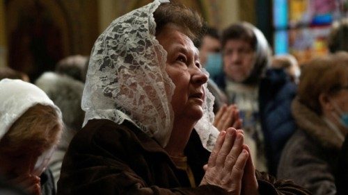 A woman prays during a Divine Liturgy at St. George Ukrainian Catholic Church in New York City Feb. ...