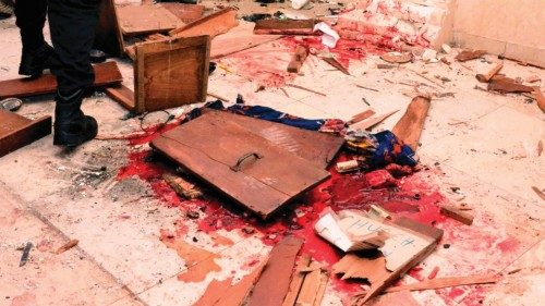 EDITORS NOTE: Graphic content / A man walk past the blood the stained floor after an attack by ...