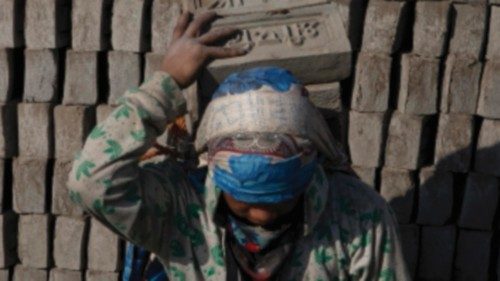 epa09664167 Migrant workers at a brick factory in Pharping, on the outskirts of Kathmandu, Nepal, 03 ...