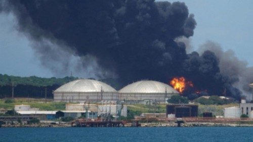 Fire is seen over fuel storage tanks that exploded near Cuba's supertanker port in Matanzas, Cuba, ...