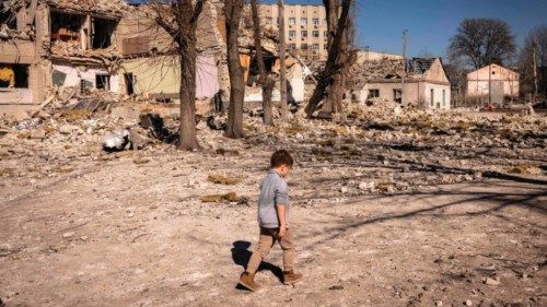 A children walks in front of a damaged school in the city of Zhytomyr, northern Ukraine, on March ...