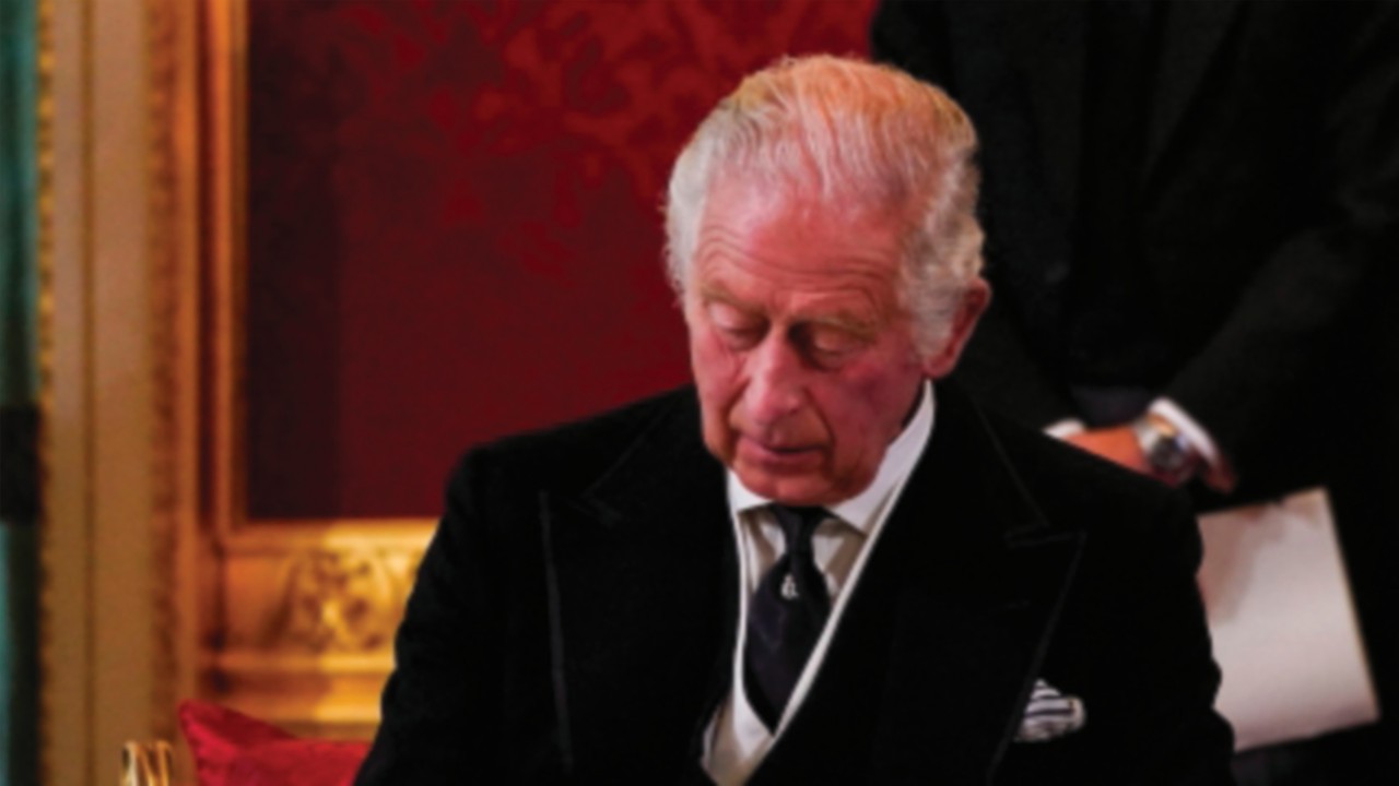 Britain's King Charles III signs an oath to uphold the security of the Church in Scotland, during a ...