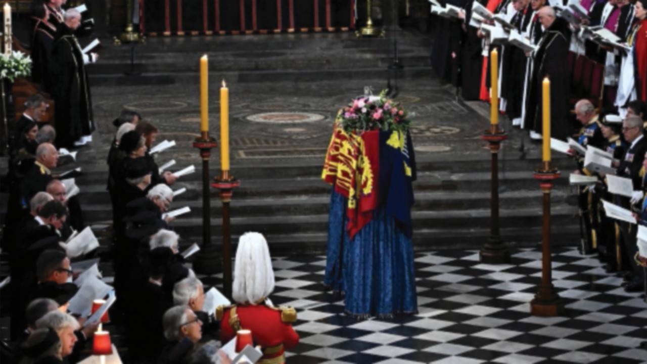 Members of the Royal family and guests sing as the coffin of Queen Elizabeth II, draped in the Royal ...