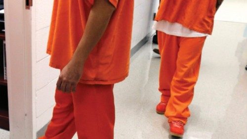 Detainees walk in a hallway at the Northwest Detention Center in Tacoma, Wash., on June 21, 2017.