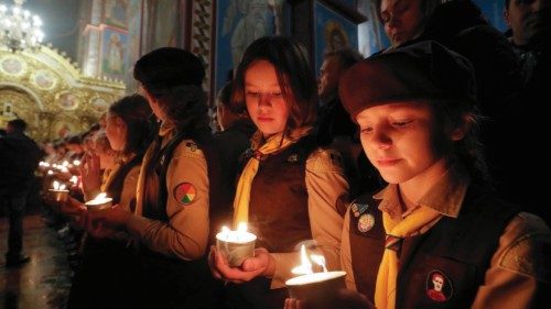 epa10361338 Members of the Plast National Scout Organization of Ukraine share the Flame of Bethlehem ...
