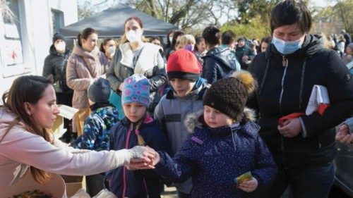 Refugees from Ukraine queue for food at a donation collection point organised by the Dresden`s ...