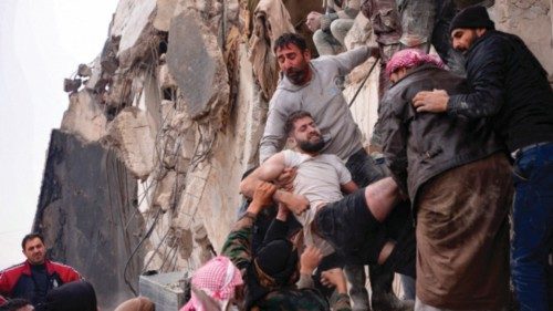 Residents retrieve an injured man from the rubble of a collapsed building following an earthquake in ...