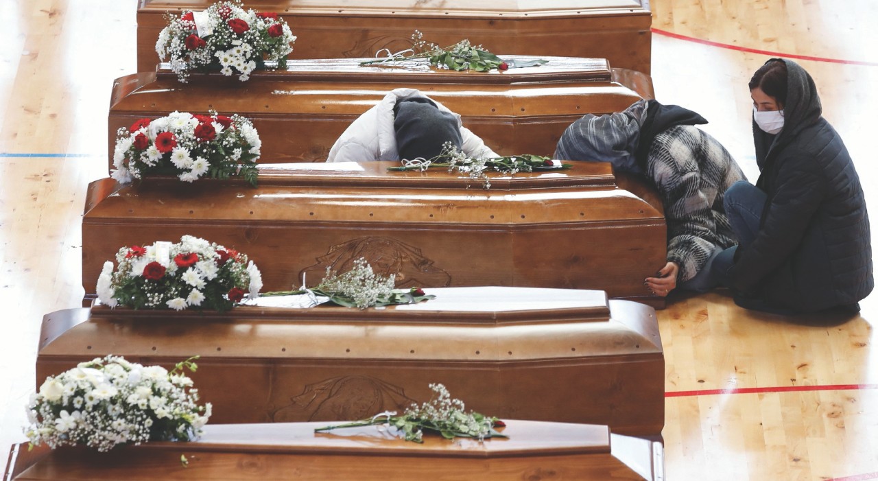 Mourners react near coffins of victims who died in a migrant shipwreck, in Crotone, Italy March 1, ...