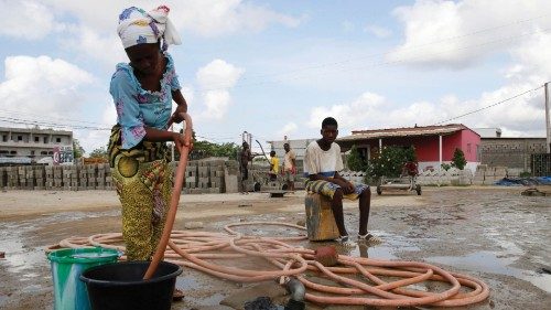 epa10535365 A woman fills a bucket with borehole water, a day before the day designated as World ...