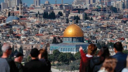Tourists stand at the Mount of Olives overlooking Jerusalem's Old City and the Dome of the Rock in ... Tourists stand at the Mount of Olives overlooking Jerusalem's Old City and the Dome of the Rock in ...
