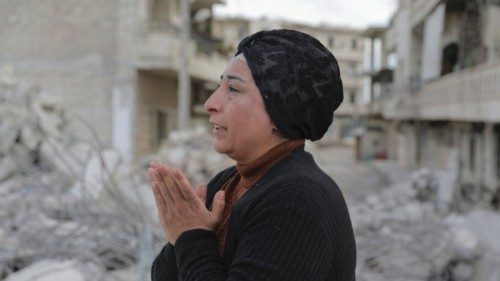 Intisar Sheikho, reacts as she stands on rubble of the building where her brother Musheer and his ...