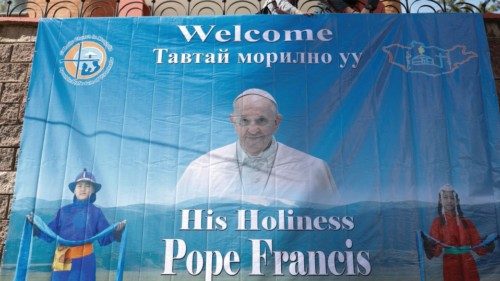 People install a poster with an image of Pope Francis outside the bishops house, where he is ...