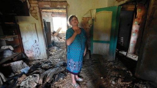 TOPSHOT - Valentyna Hleha, 60, stands in a room of her house, partially destroyed during the ...