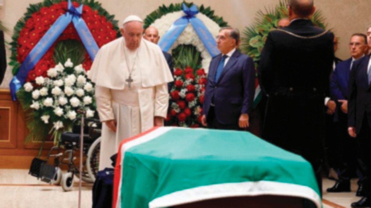 A handout photo made available by the Vatican Media shows Pope Francis paying respect at the coffin ...