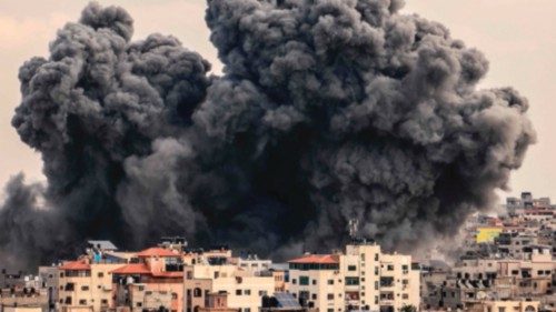 A plume of smoke rises in the sky of Gaza City during an Israeli airstrike on October 9, 2023. ...