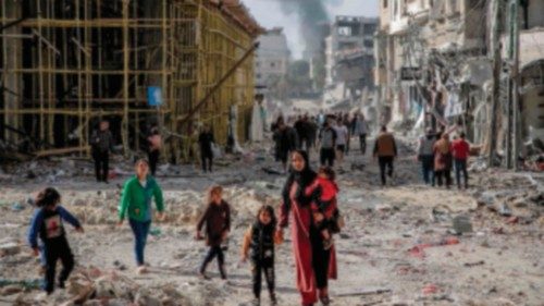 TOPSHOT - Palestinians walk amid the rubble of destroyed buildings in Gaza City on the northern Gaza ... TOPSHOT - Palestinians walk amid the rubble of destroyed buildings in Gaza City on the northern Gaza ...
