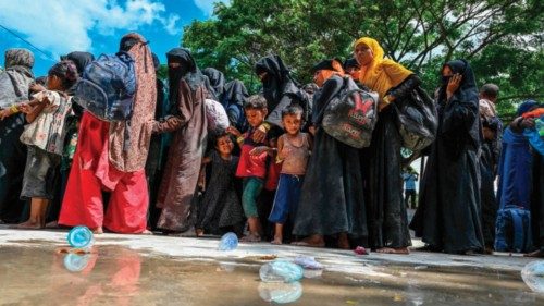 Newly-arrived Rohingya refugees wait to board trucks to transfer to a temporary shelter after ... Newly-arrived Rohingya refugees wait to board trucks to transfer to a temporary shelter after ...