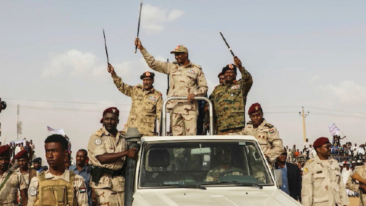 File - Gen. Mohammed Hamdan Dagalo, the deputy head of the military council, waves to a crowd during ...