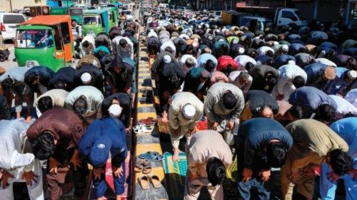 Muslim devotees offer first Friday prayers during the Islamic holy fasting month of Ramadan outside ...
