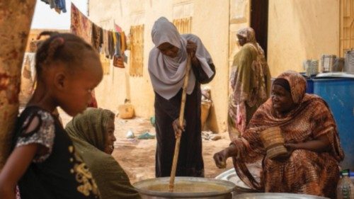 Sudanese women from community kitchens, run by local volunteers, prepare meals for people who are ... Sudanese women from community kitchens, run by local volunteers, prepare meals for people who are ...