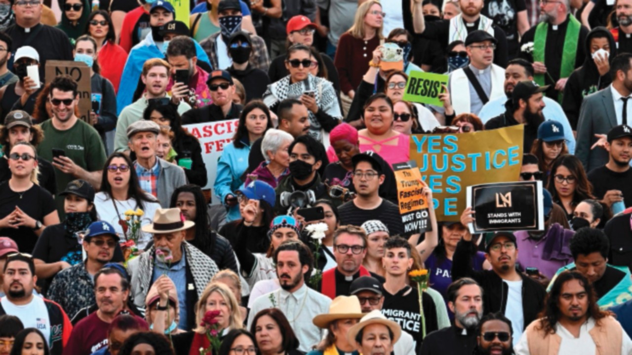 People attending a prayer vigil walk to the Federal Building in downtown Los Angeles as protests ...